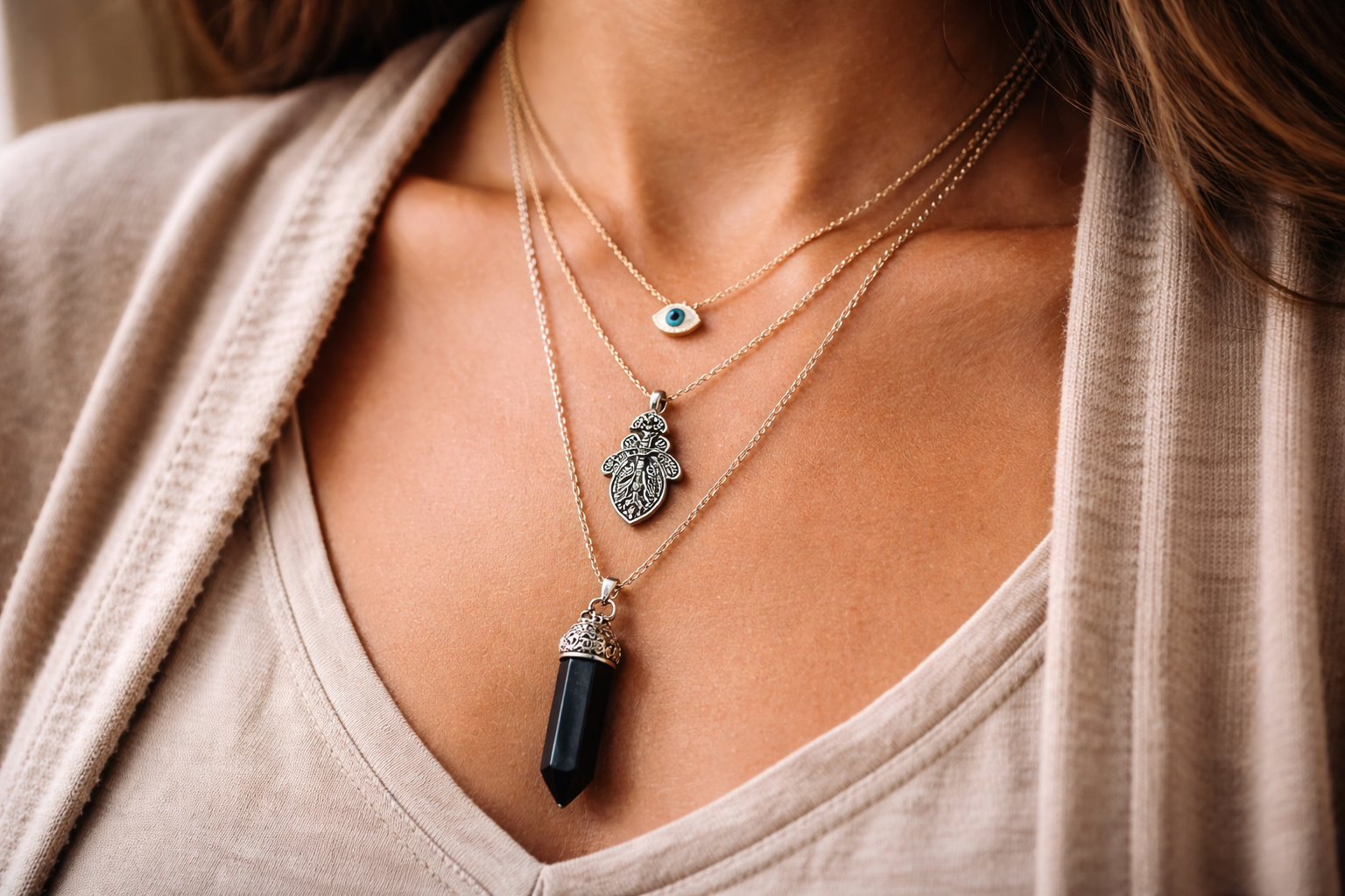 Necklace length and layering example showing small protection pendants at different chain lengths